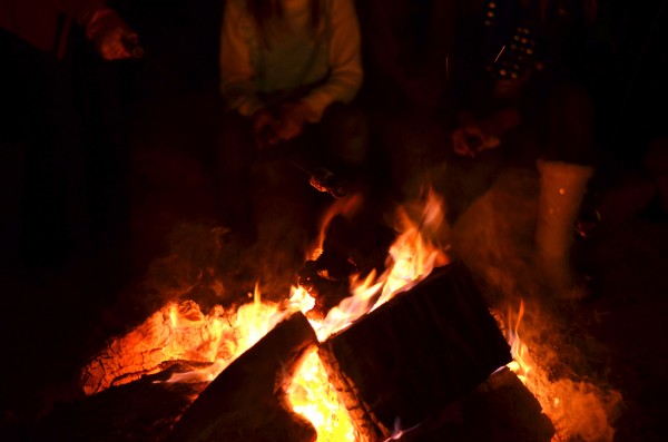 Friends gather around the yule log at the Trail of Lights in Wimberley to make smores. Ready-to-roast smores can be purchased at the event for just a buck. Photo: Shea Carley